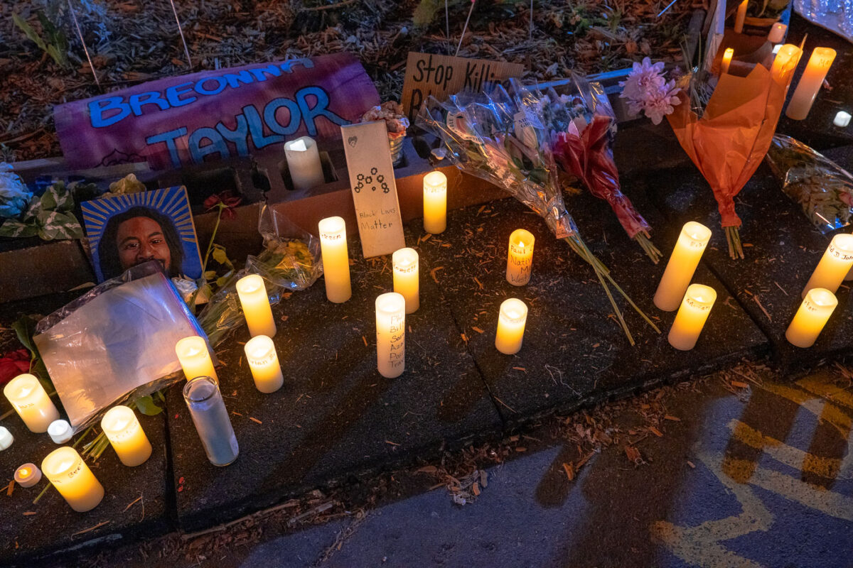 Candles displayed with the names of victims of police violence at George Floyd Square on the 1-year anniversary of his murder.