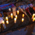 Candles displayed with the names of victims of police violence at George Floyd Square on the 1-year anniversary of his murder.