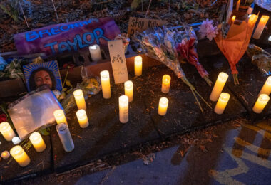 Candles displayed with the names of victims of police violence at George Floyd Square on the 1-year anniversary of his murder.