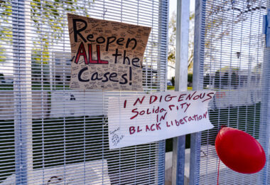 Signs attached to security fencing outside the Brooklyn Center Police Department following the death of Daunte Wright.