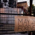 A "May 28th Forever" sign hangs on the third precinct on the 1 year anniversary of it burning.