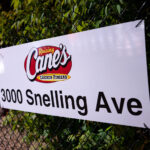 A sign on a fence at a newly opened Raising Cane's Chicken Fingers restaurant in Minneapolis. It replaces an Arby's that was burned down following the murder of George Floyd.