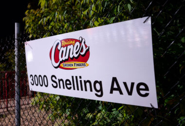A sign on a fence at a newly opened Raising Cane's Chicken Fingers restaurant in Minneapolis. 

It replaces an Arby's that was burned down following the murder of George Floyd.