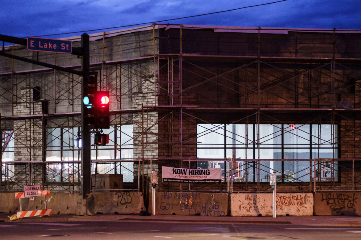 A "now hiring" sign up at the AutoZone that's being rebuilt. The AutoZone was the first store to be lit on fire during the 2020 Minneapolis uprising.