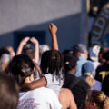 A child raises her fist during a performance of Common at George Floyd Square during Rise and Remember 2021.