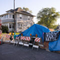 Black Lives Matter sign hung over blue tarps over barricades at 38th Street and Elliott at George Foyd Square. City workers removed barricades the day before.