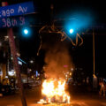 Protesters burn garbage cans in the evening after Winston Smith was killed by law enforcement in the nearby parking garage.