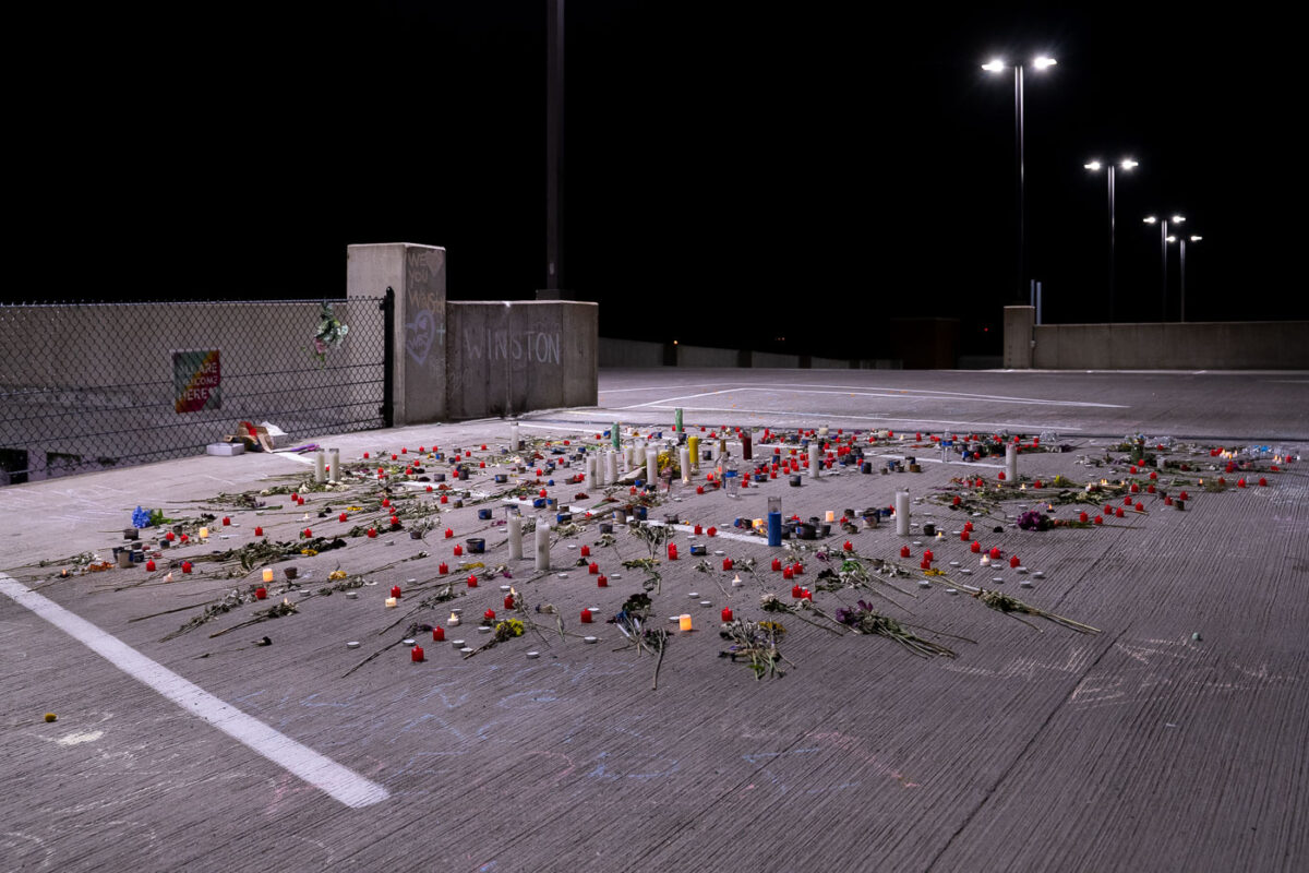 Roses and candles cover the ground where Winston Smith was killed by a Federal Task Force on June 3rd.