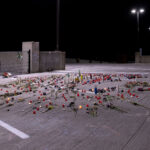 Roses and candles cover the ground where Winston Smith was killed by a Federal Task Force on June 3rd.