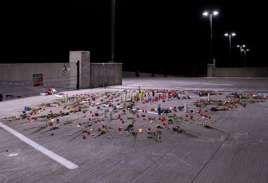 Roses and candles cover the ground where Winston Smith was killed by a Federal Task Force on June 3rd.