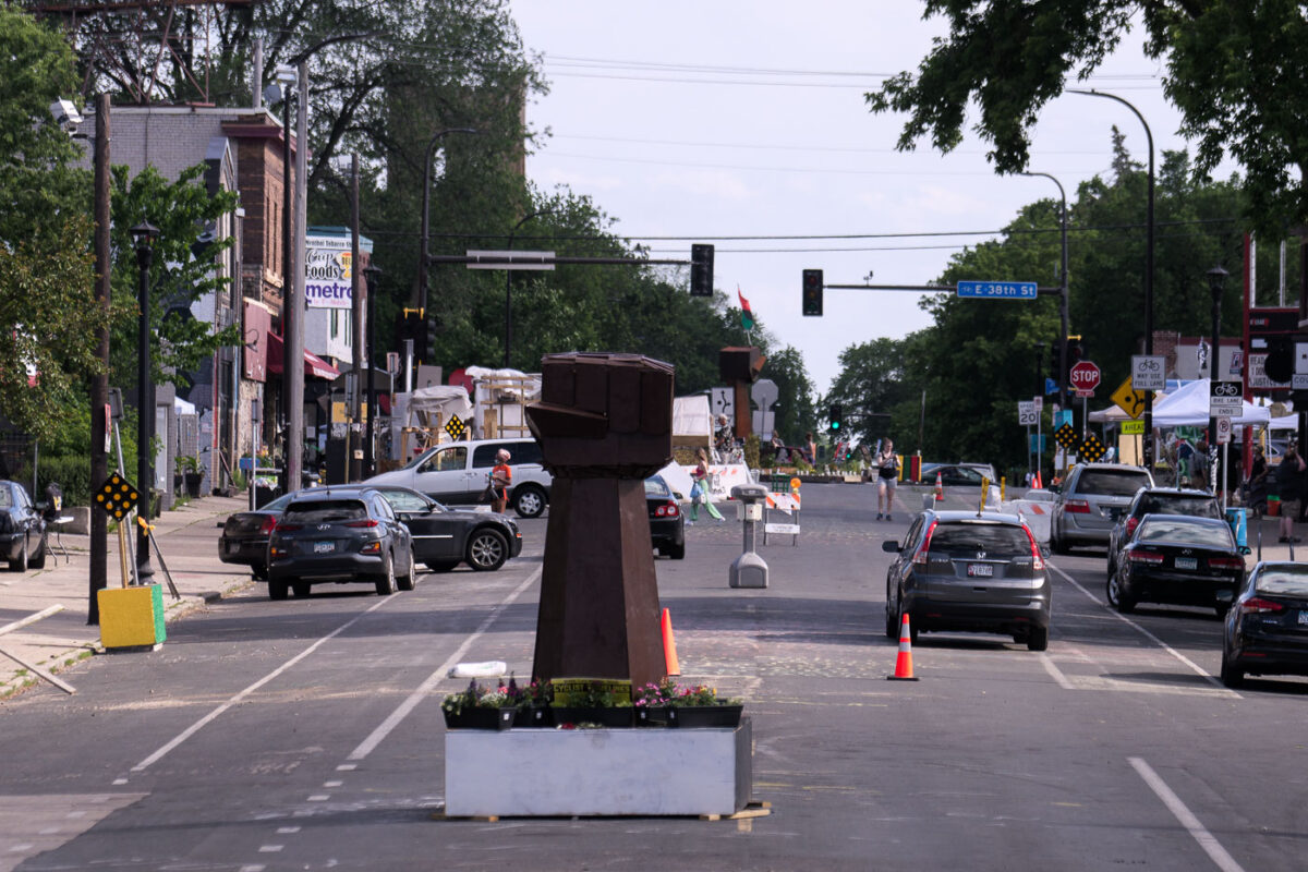 Vehicles drive through George Floyd Square three days after the city removed barricades to open it to vehicular traffic.