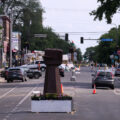 Vehicles drive through George Floyd Square three days after the city removed barricades to open it to vehicular traffic.