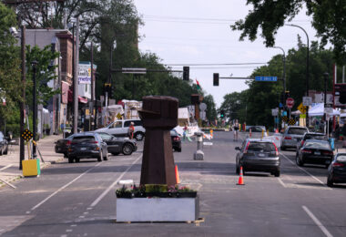 Vehicles drive through George Floyd Square three days after the city removed barricades to open it to vehicular traffic.
