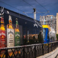 A Jack Daniel's wrapped light rail train in Minneapolis, Minnesota. Cedar Riverside apartments in the background.