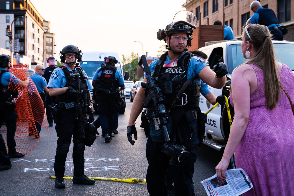 Minneapolis Police confront a woman while they clear out protesters and their barricades from Lake Street and Hennepin Avenue. Protesters have been gathered since the June 3rd and June 13th killings of Winston Smith and Deona Marie.

Winston Smith was killed after Hennepin and Ramsey County officers fired their weapons while part of a Federal Task Force serving a warrant. 

Deona Marie was killed when Nicholas Kraus drove his vehicle into those protesting the killing of Smith.