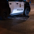 A Minneapolis Police squad car drives over "Abolish The Police" graffiti on Lake Street in Uptown Minneapolis.