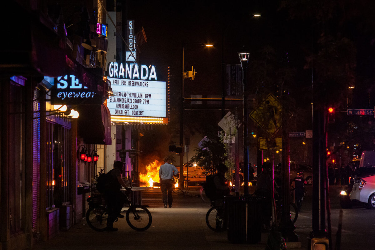 Minneapolis Police on Hennepin Avenue while fires burn in the streets following the June 3rd shooting death of Winston Smith by Federal law enforcement.