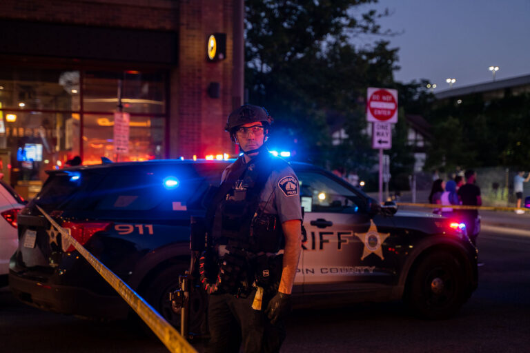 Minneapolis Police officer as sun goes down 4 Minneapolis Police officer on Hennepin Avenue while they clear our protests that followed the June 3rd and June 13th killings of Winston Smith and Deona Marie.Winston Smith was killed after Hennepin and Ramsey County officers fired their weapons while part of a Federal Task Force serving a warrant. Deona Marie was killed when Nicholas Kraus drove his vehicle into those protesting the killing of Smith.