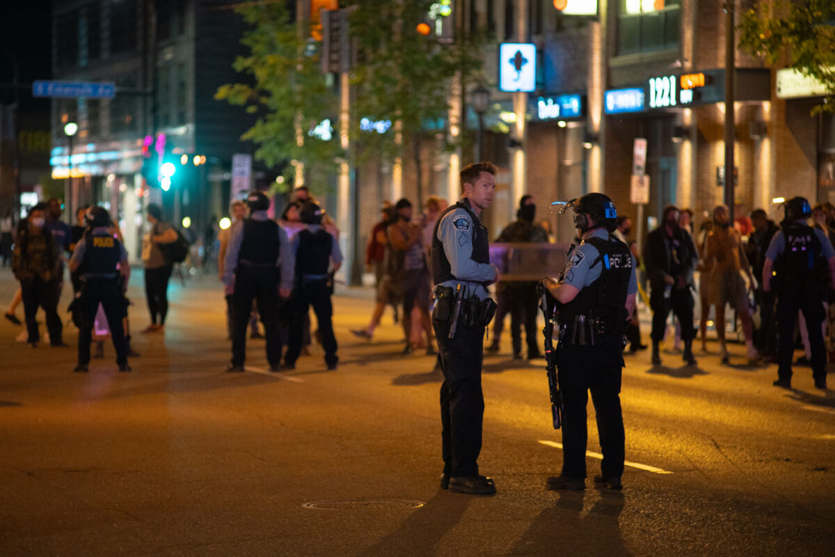 Minneapolis Police clash with protesters who had gathered around the parking garage in Minneapolis where Winston Smith was shot and killed by police hours earlier.