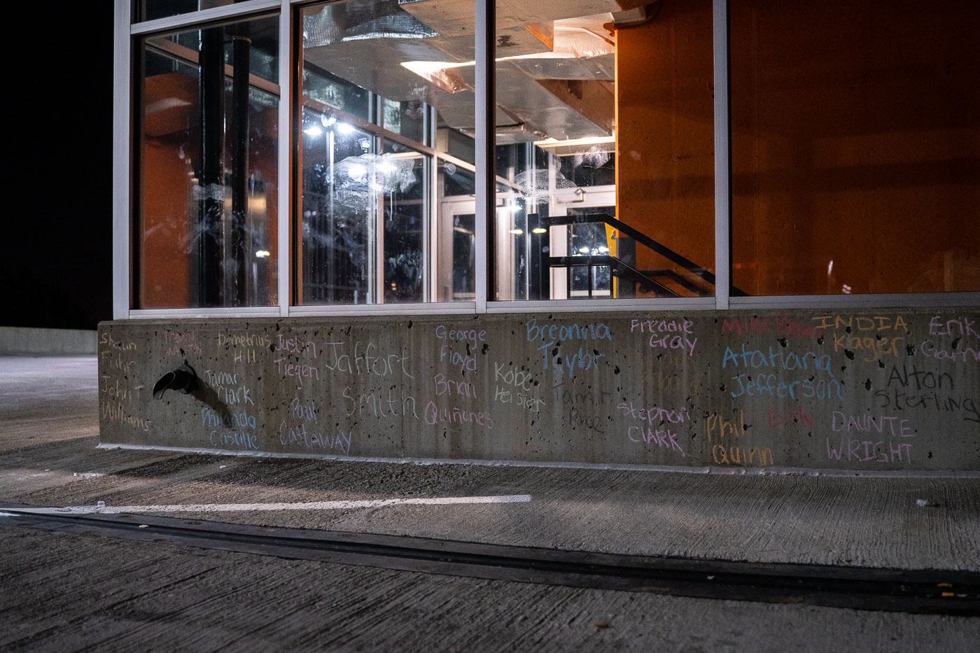 Names of police violence victims in chalk in Uptown Minneapolis