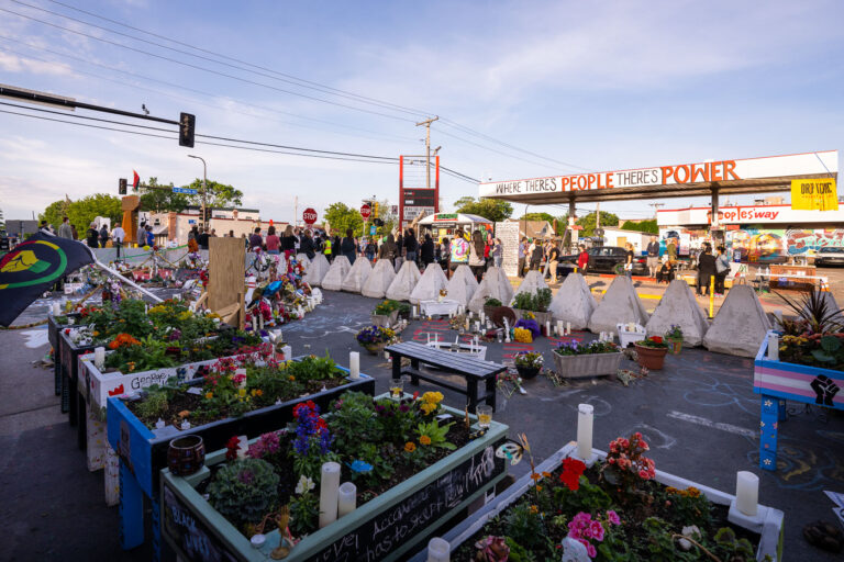 New barricades placed by the city at George Floyd Square 2 Community gathering at George Floyd Square after city officials cleared out barricades and added new barricades around the memorials.