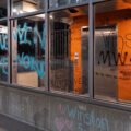 Graffiti on windows on the top floor of the Seven Points parking ramp where Winston Smith was shot and killed by a Federal Task Force on June 3rd.