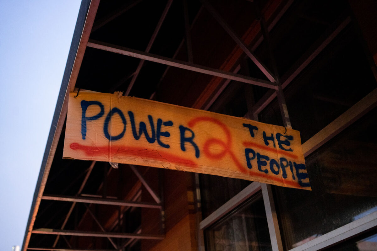 A sign reading "Power 2 the people" hanging from Seven Points mall. Winston Smith was killed earlier in the month by a Federal Task Force.