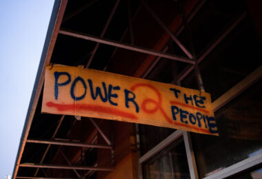 A sign reading "Power 2 the people" hanging from Seven Points mall. Winston Smith was killed earlier in the month by a Federal Task Force.