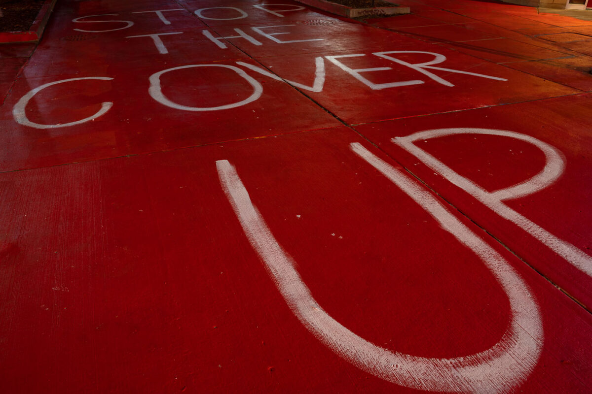 "Stop The Cover Up" written on a private drive near the parking garage where Winston Smith was killed by Law Enforcement on June 3rd. 10 days later Deona Marie was killed when a man drove his vehicle through barricades meant to protect protesters.