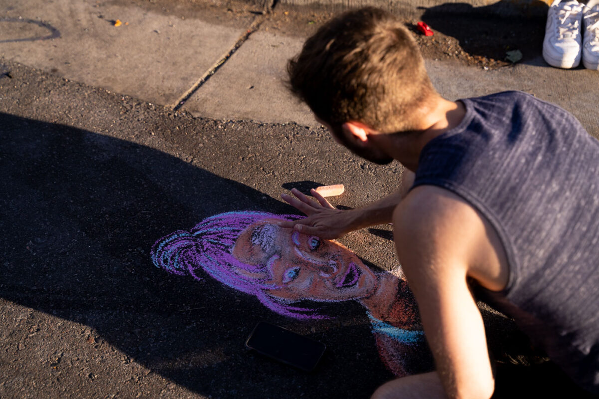 A protester draws Deona Marie in chalk on Lake Street. Marie, who was protesting the June 3rd law enforcement shooting death of Winston Smith, was killed when Nicholas Kraus drove his vehicle into those protesting the killing of Smith.