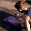 A protester draws Deona Marie in chalk on Lake Street. Marie, who was protesting the June 3rd law enforcement shooting death of Winston Smith, was killed when Nicholas Kraus drove his vehicle into those protesting the killing of Smith.