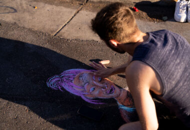 A protester draws Deona Marie in chalk on Lake Street. Marie, who was protesting the June 3rd law enforcement shooting death of Winston Smith, was killed when Nicholas Kraus drove his vehicle into those protesting the killing of Smith.
