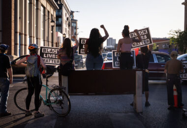 Protesters holding up Black Lives Matter signs on Lake Street at Hennepin Avenue with barricades in place. Protesters have been protesting the June 3rd law enforcement killing of Winston Smith and the June 13th killing of Deona Marie.

Marie was killed when Nicholas Kraus drove his vehicle into those protesting the killing of Smith.