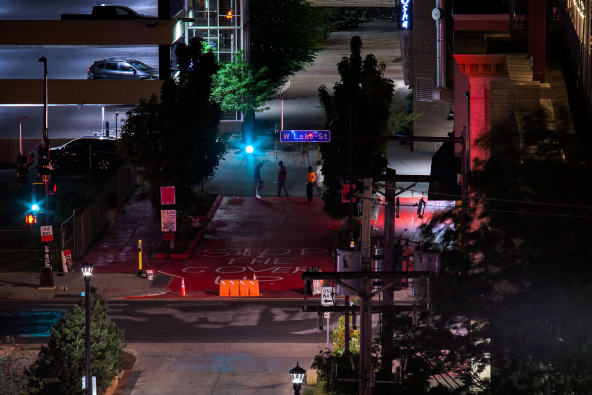 Protesters paint "Stop the cover up" on a private drive outside of where Winston Smith was killed by law enforcement on June 3rd. This was the 2nd time it was painted red in as many days after the red was removed.