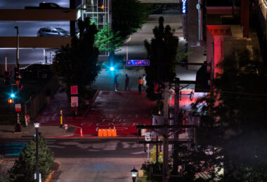 Protesters paint "Stop the cover up" on a private drive outside of where Winston Smith was killed by law enforcement on June 3rd. This was the 2nd time it was painted red in as many days after the red was removed.