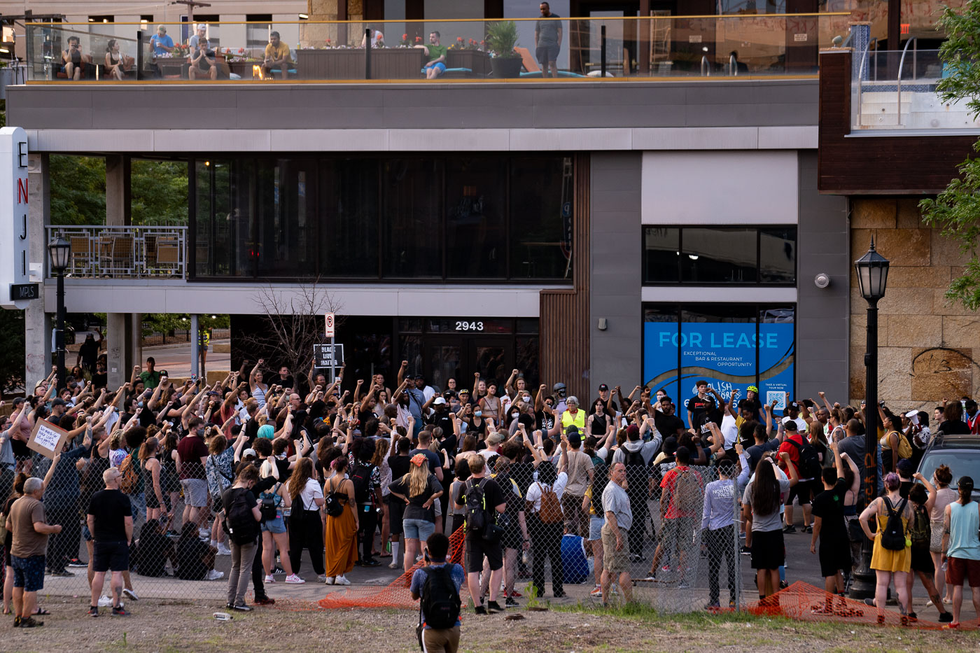 Protesters raise fists on Lake Street in Uptown Minneapolis