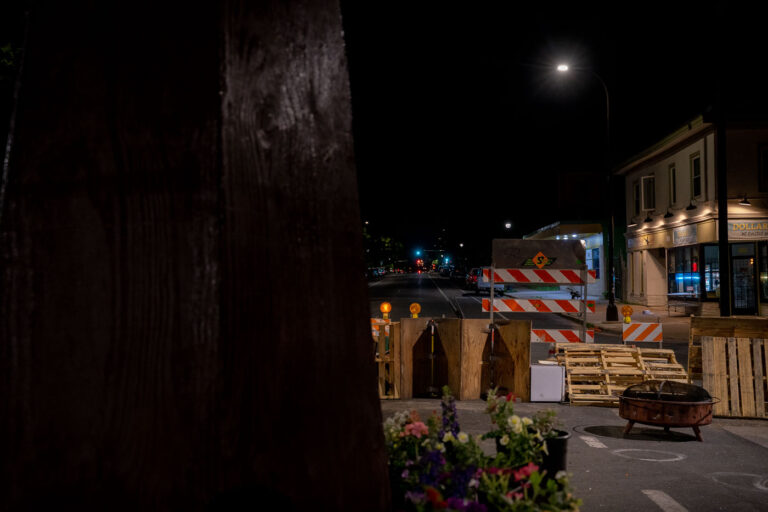 Street barricades seen behind George Floyd Square fist 3 Street barricades at 37th and Chicago Ave. The barricades replace those the city removed days earlier in attempts to open up the street to vehicular traffic.