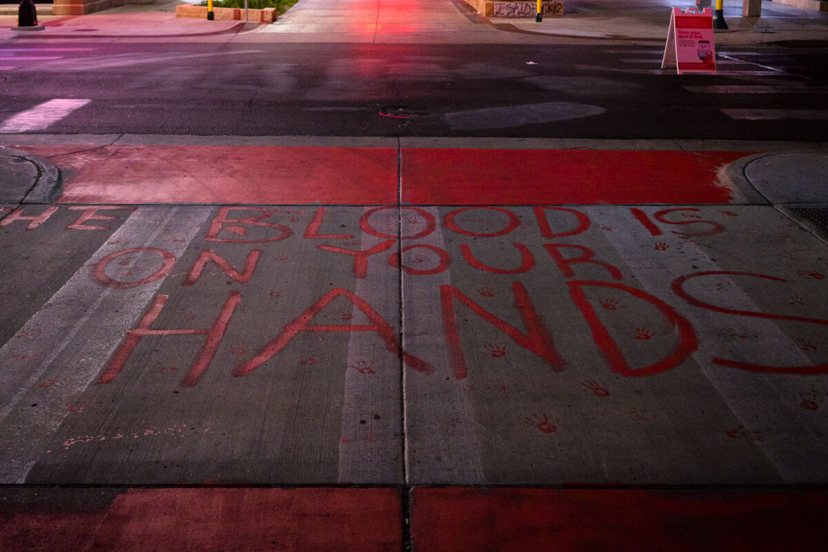 "The Blood Is On Your Hands" written on a private drive outside the parking ramp that Winston Smith was killed by law enforcement on June 3rd, 2021.