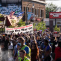 Protesters carrying signs that read "This is a Revolt Against Racism! Stop the War on Black America!" while marching through the streets of Uptown Minneapolis.

Protesters have been marching since the June 3rd law enforcement shooting death of Winston Smith and the June 13th killing of protester Deona Marie. Marie was killed when Nicholas Kraus drove his vehicle into those protesting the killing of Smith.