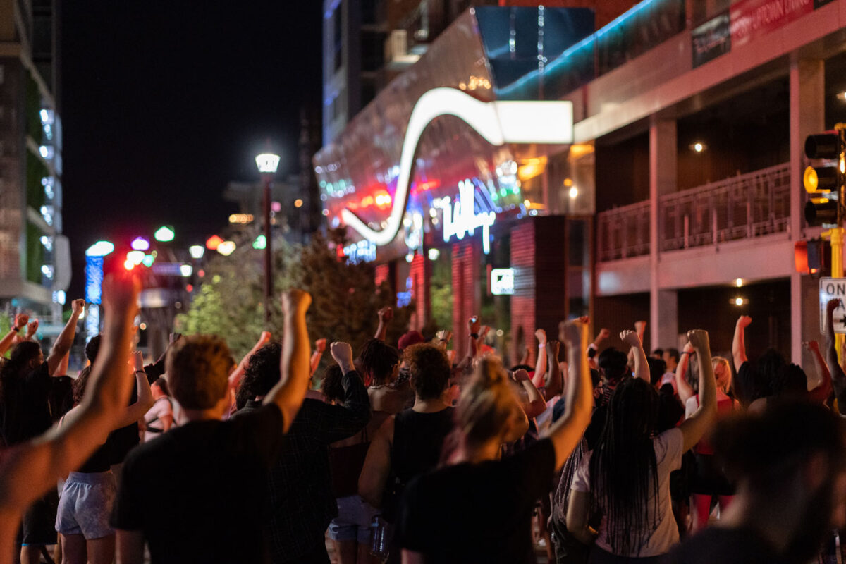 Protesters hold their firsts up during a march in Uptown Minneapolis on the third day of protests following the law enforcement shooting death of Winston Smith on June 3rd.