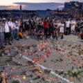 Community gathers around a candle lit vigil where Winston Smith was killed the day earlier by a Federal task force.