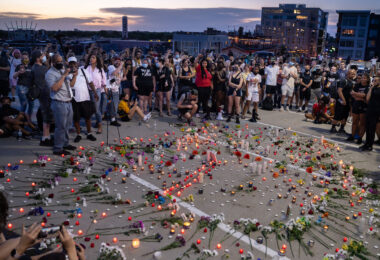 Community gathers around a candle lit vigil where Winston Smith was killed the day earlier by a Federal task force.