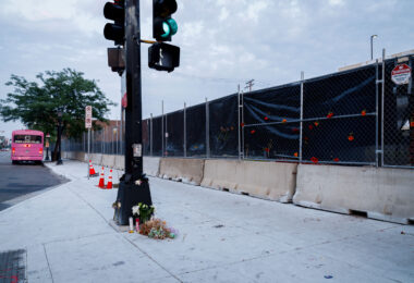 A few candles and flowers remain at the memorial for Deona Knajdek a week after the space was cleared by private security contractors. Knajdek was killed while protesting the law enforcement shooting death of Winston Smith 10 days prior when a car dove through barricades put in place by protesters.