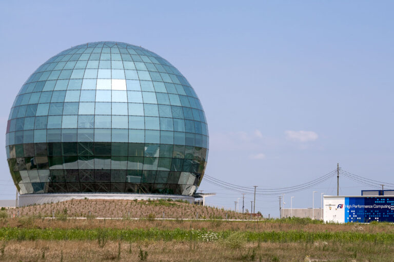 Foxconn Globe and Data Center — Mount Pleasant, WI 4 The glass globe structure at the Foxconn Industrial Internet complex in Mount Pleasant, Wisconsin — a striking symbol of the state’s ambitious but scaled-back high-tech manufacturing project. Originally promoted as part of a massive LCD fabrication plant, the globe now fronts a data and research facility built by Foxconn Industrial Internet (Fii). The site has become emblematic of shifting industrial promises in the Midwest, where infrastructure outpaced production.
