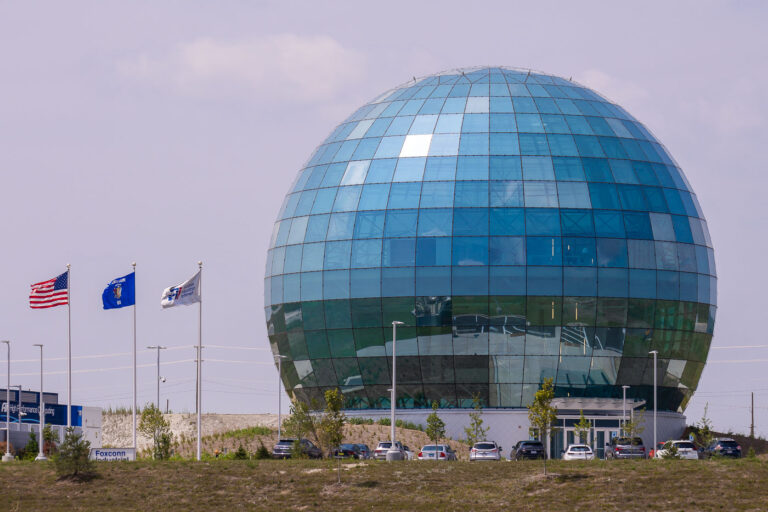 Foxconn Globe Data Center, Mount Pleasant, Wisconsin 1 The Foxconn “Globe” in Mount Pleasant, Wisconsin, is a striking spherical glass structure originally envisioned as part of the company’s high-tech manufacturing and research campus. Completed in the late 2010s, the 80-foot-tall mirrored globe houses Foxconn’s data and network operations center, symbolizing global connectivity and innovation. The building’s reflective blue-green panels and geometric precision make it one of the most recognizable and unconventional architectural landmarks in southeastern Wisconsin.