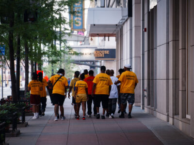 Outreach Experts Walk Downtown Minneapolis Sidewalk
