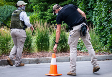 Armed security placing cones outside the Seven Points Mall parking garage.