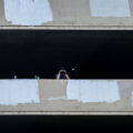 A security guard looks down at those on Lake Street with a pair of binoculars.