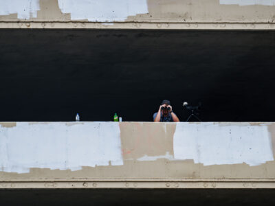 Security guard with binoculars overlooks Lake Street, Minneapolis