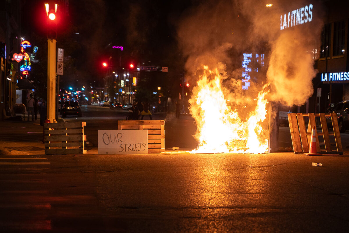 Protesters close down vehicle traffic on streets near the Winston Smith and Deona Marie memorials in Uptown Minneapolis.